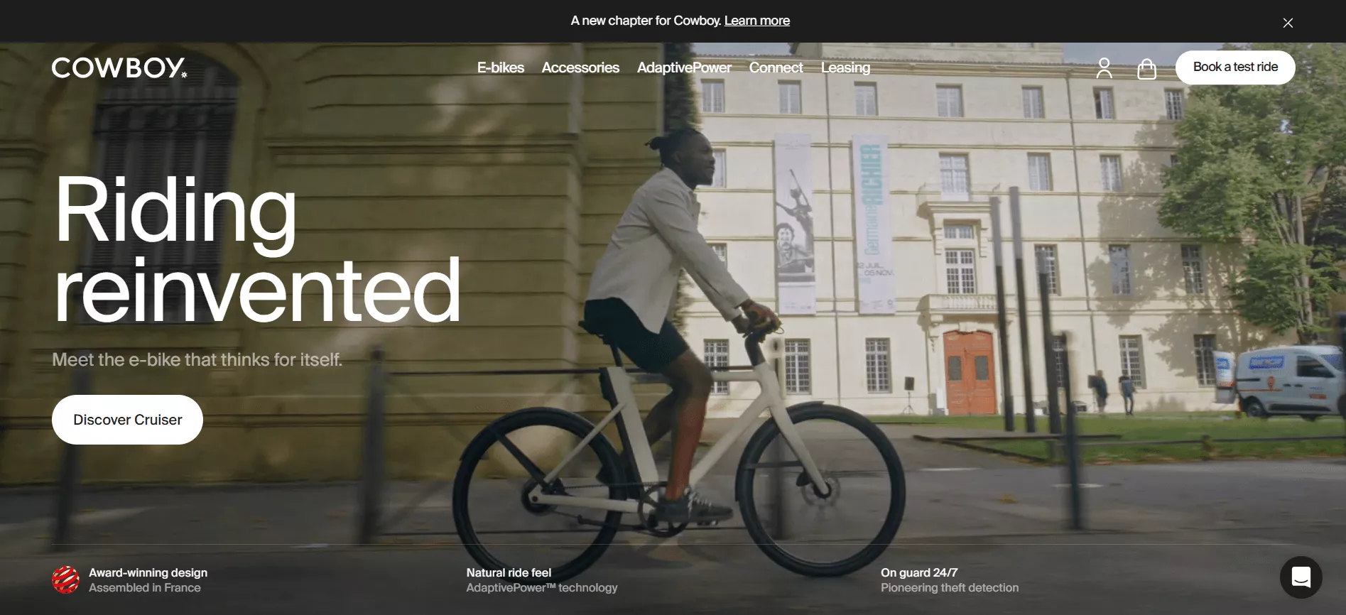 Shopify stores: A person rides a white e-bike past a historic stone building with banners. Text reads: “Riding reinvented. Meet the e-bike that thinks for itself.” The webpage offers options like e-bikes, accessories, and booking a test ride.
