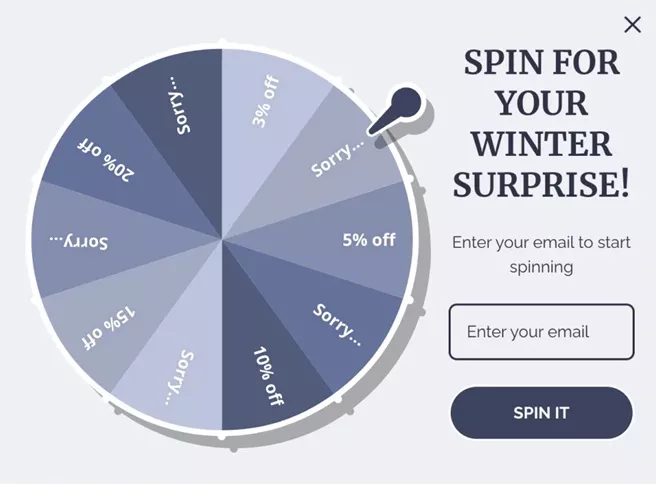 Email list building spin-to-win popup with winter discount wheel and email signup form